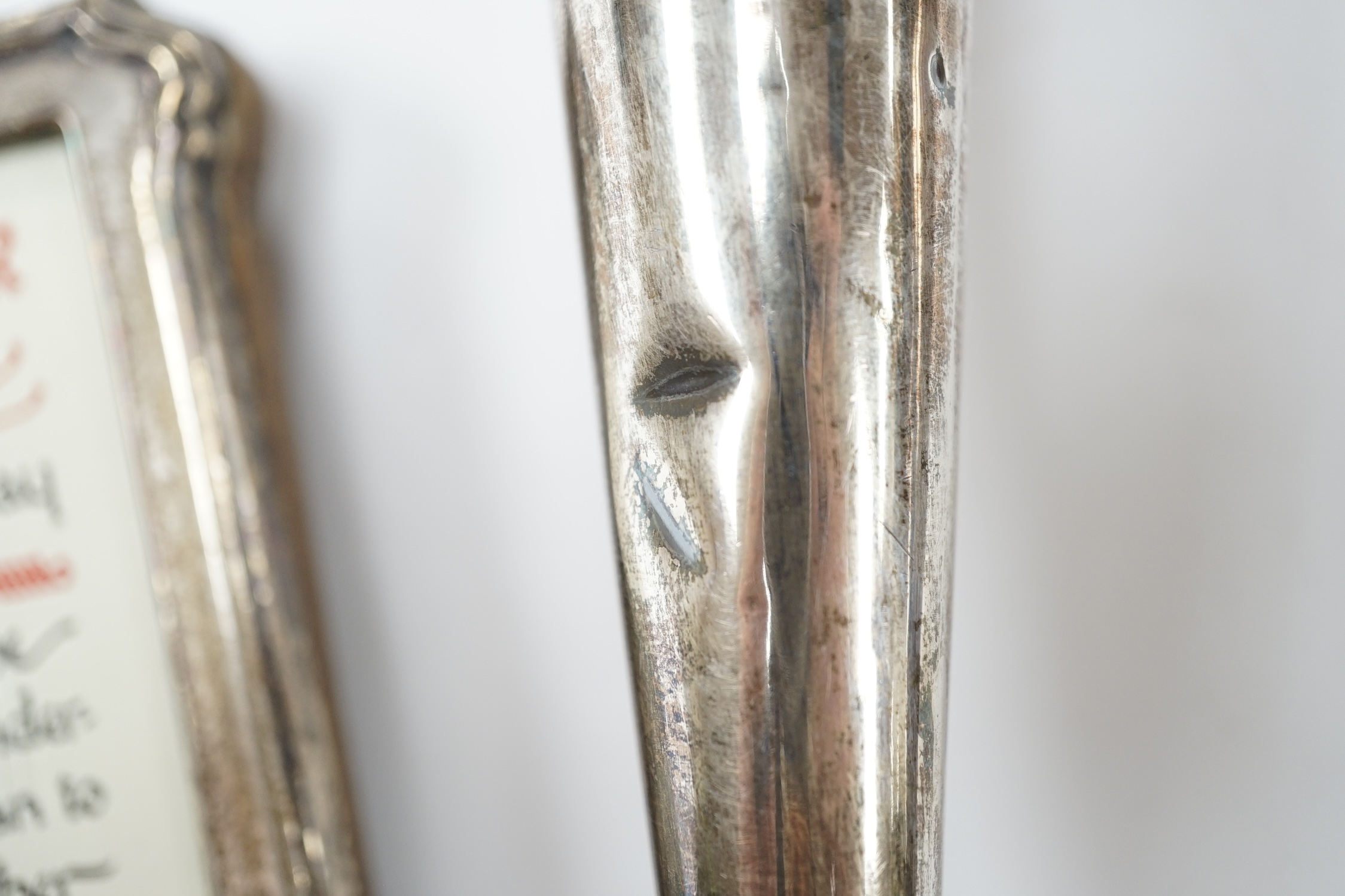 A pair of 1940's silver trumpet vases, 19.7cm, weighted, and a George V silver mounted photograph frame. Condition - poor